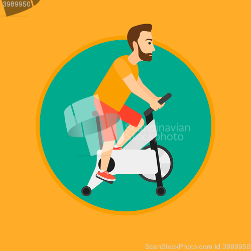 Image of Man riding stationary bicycle.