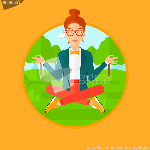 Image of Business woman meditating in lotus position.