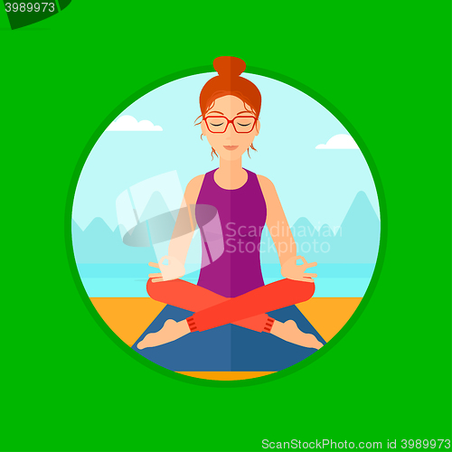 Image of Woman meditating in lotus pose.