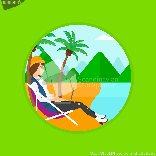 Image of Business woman working on laptop on the beach.
