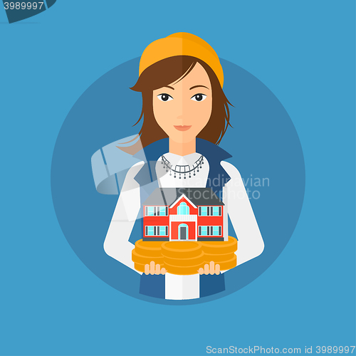 Image of Woman holding house model.