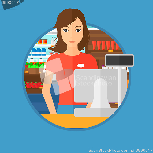 Image of Cashier standing at the checkout in supermarket.