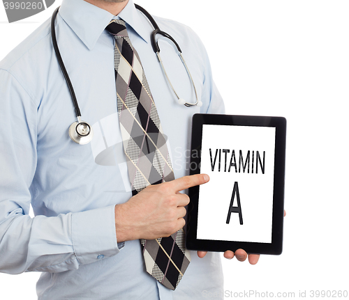 Image of Doctor holding tablet - Vitamin A