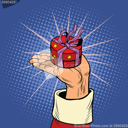 Image of Hand of Santa Claus with round gift box