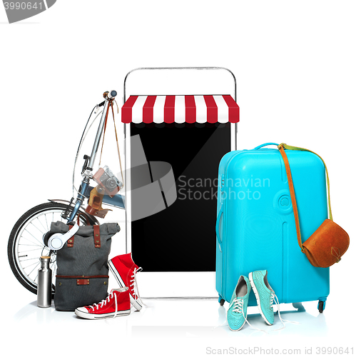 Image of The blue suitcase, sneakers, clothing, hat, and phone on white background.
