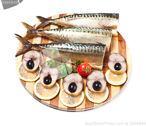 Image of sliced herring on wooden plate