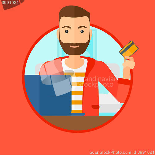 Image of Man shopping online using his laptop.