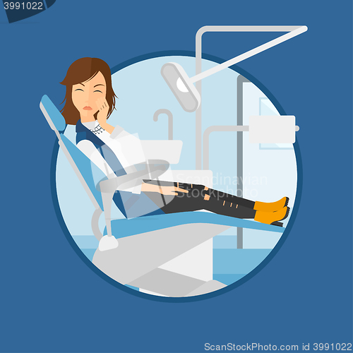 Image of Woman suffering in dental chair.