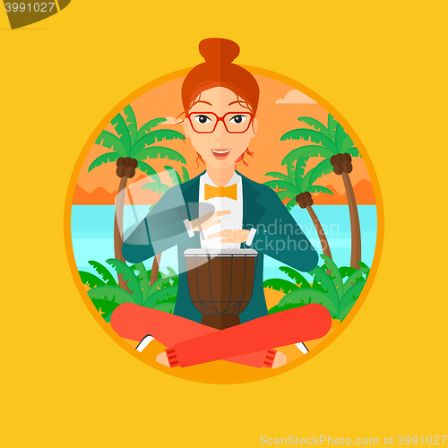 Image of Woman playing ethnic drum.