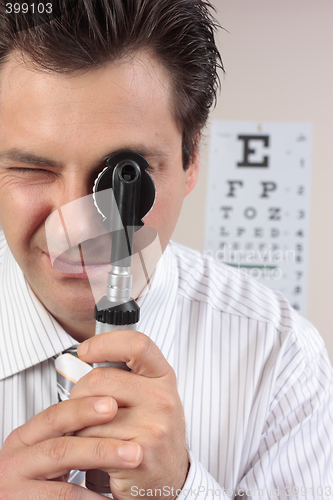 Image of Eye doctor using opthalmoscope