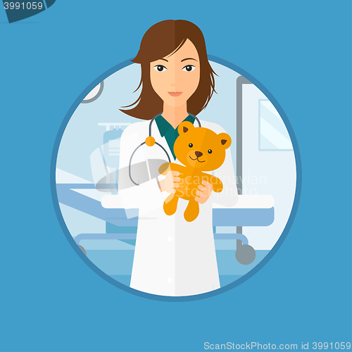 Image of Pediatrician doctor holding teddy bear.