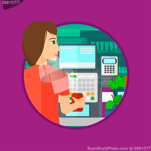 Image of Cashier standing at the checkout in supermarket.