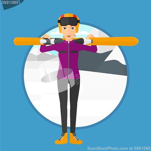 Image of Woman holding skis.