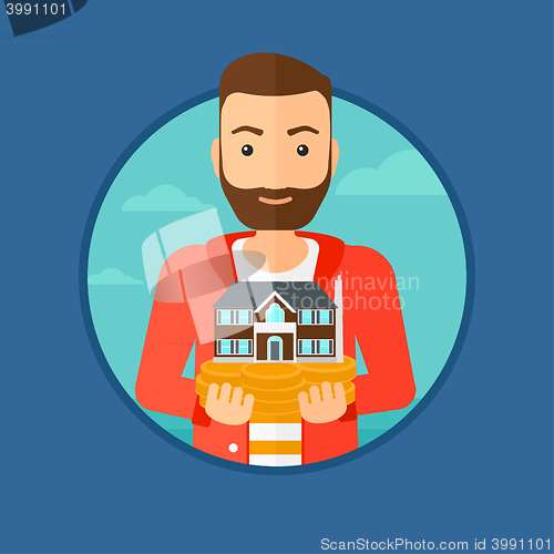 Image of Man holding house model.