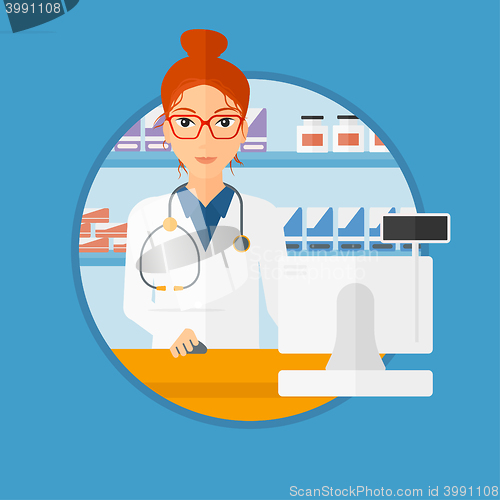 Image of Pharmacist at counter with computer monitor.