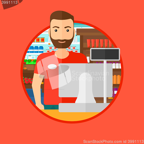 Image of Cashier standing at the checkout in supermarket.