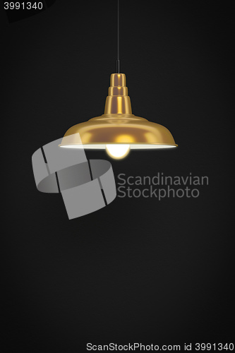 Image of golden lamp in front of a dark wall