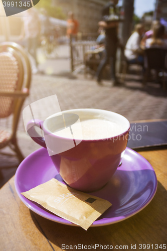 Image of purple cup of coffee outdoors