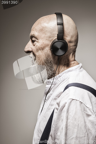 Image of elderly bald head man with headphones