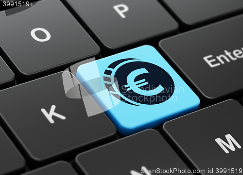 Image of Currency concept: Euro Coin on computer keyboard background