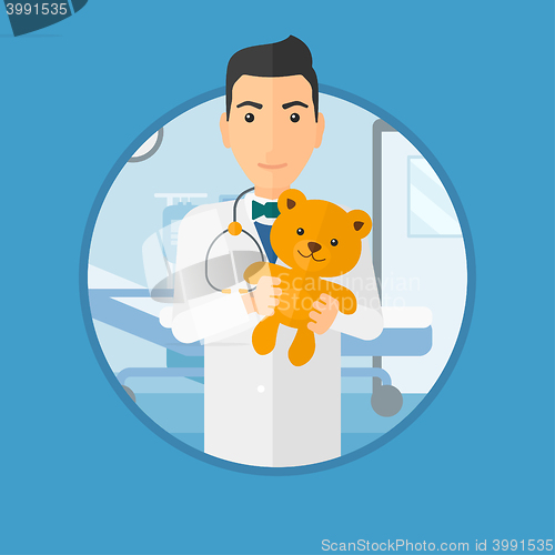 Image of Pediatrician doctor holding teddy bear.