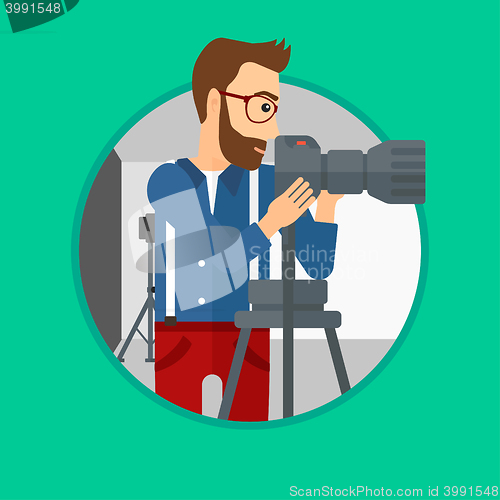Image of Photographer working with camera on tripod.
