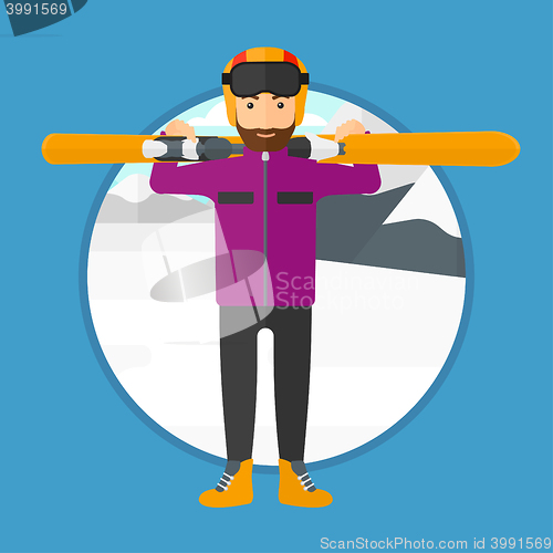 Image of Man holding skis.