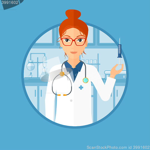 Image of Laboratory assistant with syringe in lab.