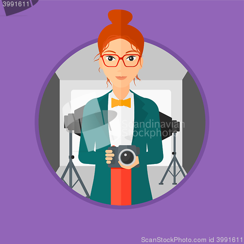 Image of Smiling photographer holding camera.