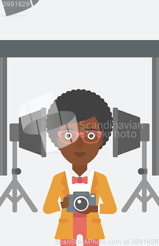 Image of Smiling photographer holding camera.