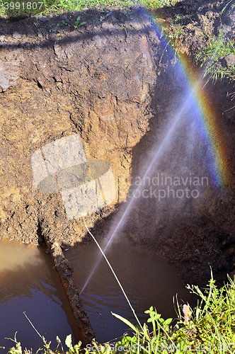 Image of The water jet in the form of leakage in the damaged metal pipe at the production site