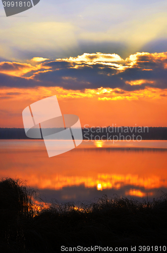 Image of Sunrise over the lake early in the morning with beautiful clouds