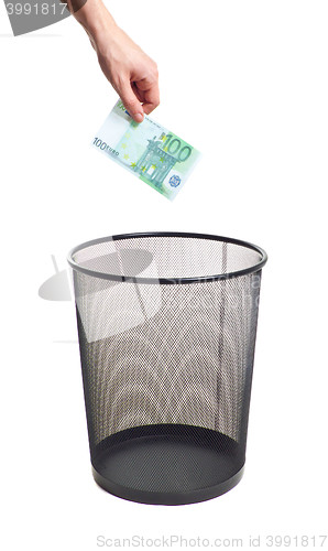 Image of hand gold euro to trash can