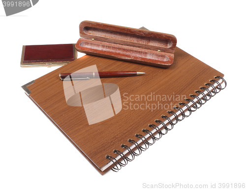 Image of wooden notebook with pen isolated