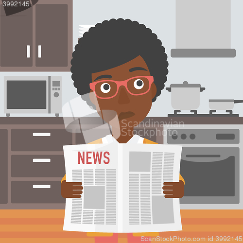 Image of Woman reading newspaper.