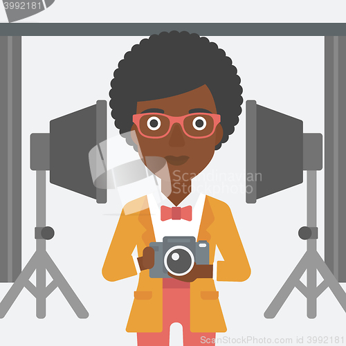 Image of Smiling photographer holding camera.