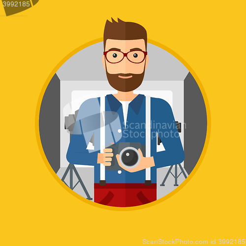 Image of Photographer with camera in photo studio.