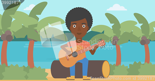 Image of Woman playing guitar.