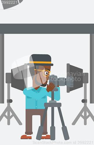 Image of Photographer working with camera on a tripod.