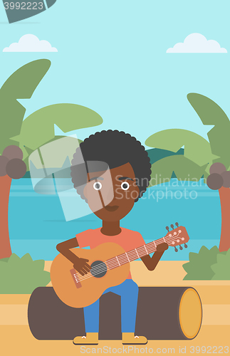 Image of Woman playing guitar.