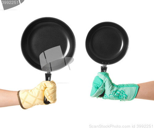 Image of two hands in gloves holding pan\'s