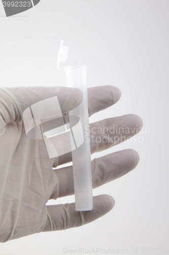 Image of Hand holding medical tube