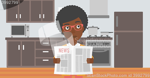 Image of Woman reading newspaper.