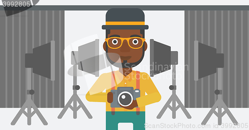 Image of Smiling photographer holding camera.