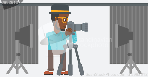 Image of Photographer working with camera on a tripod.