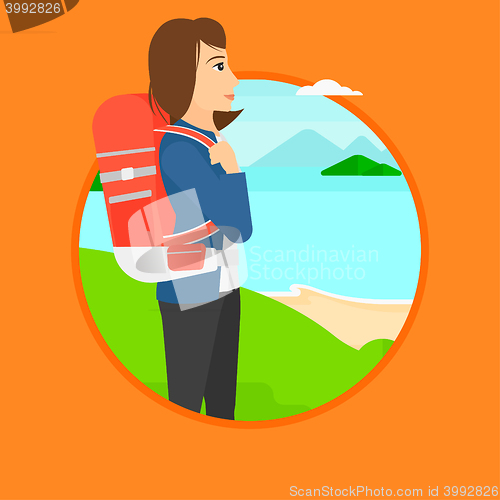 Image of Woman with backpack hiking.