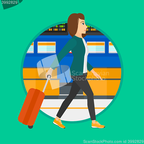 Image of Woman walking with suitcase at the airport.