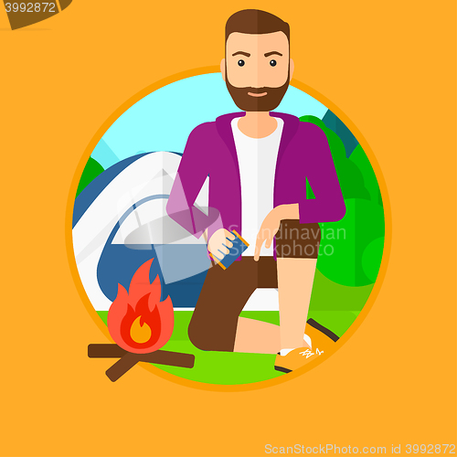 Image of Man kindling campfire.