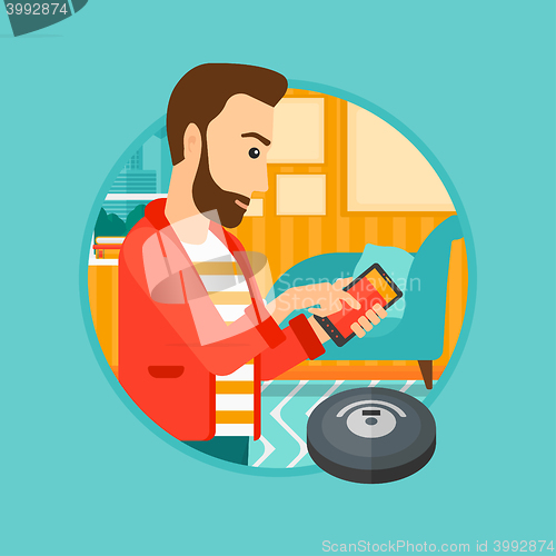 Image of Man controlling vacuum cleaner with smartphone.