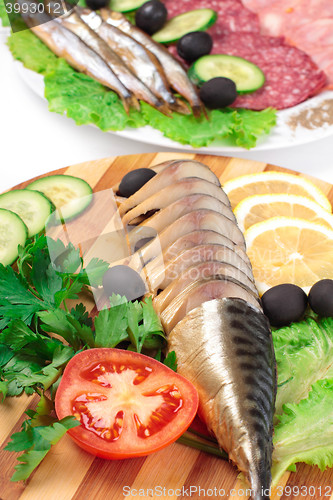 Image of sliced herring on wooden plate